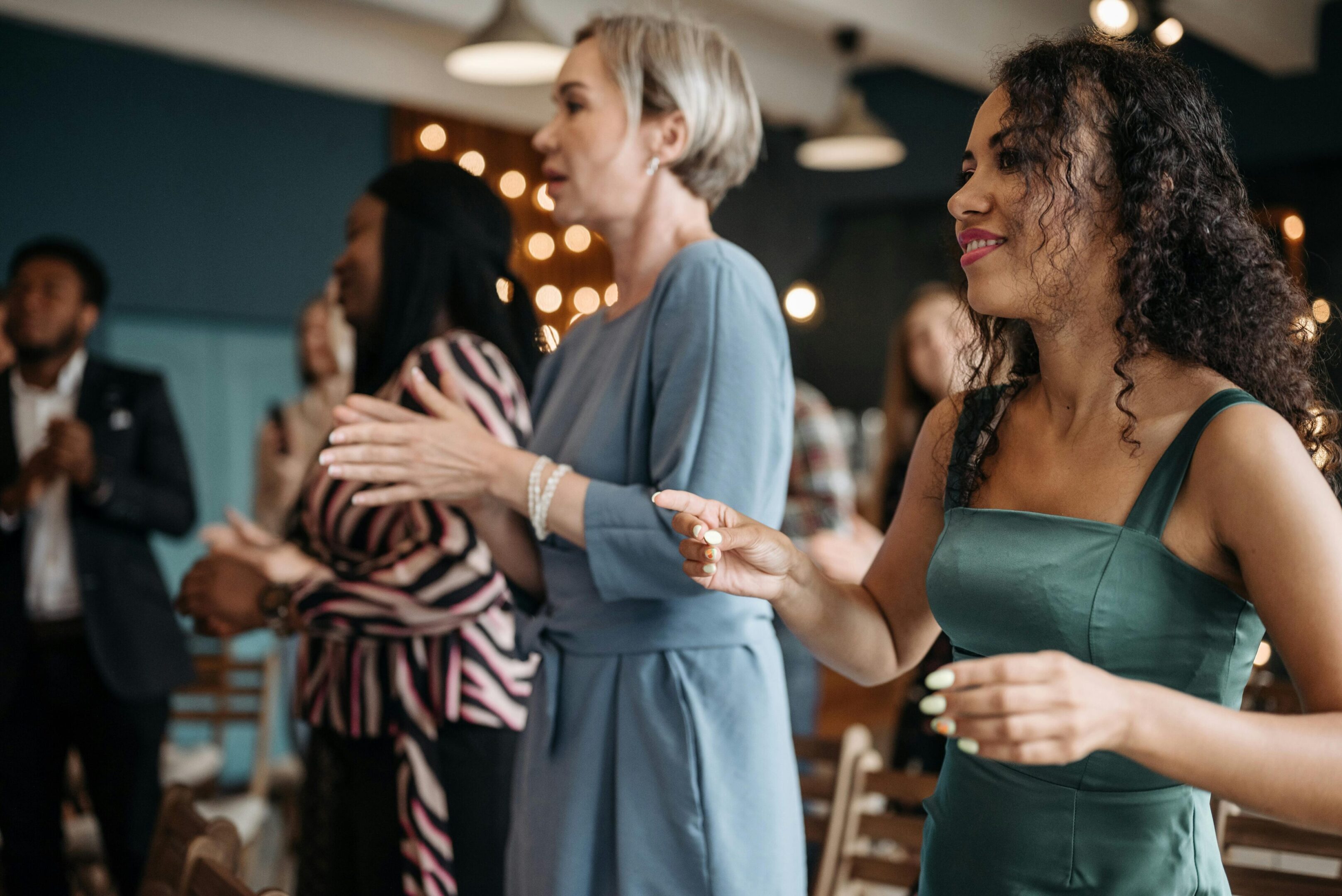 A group of women standing around each other.